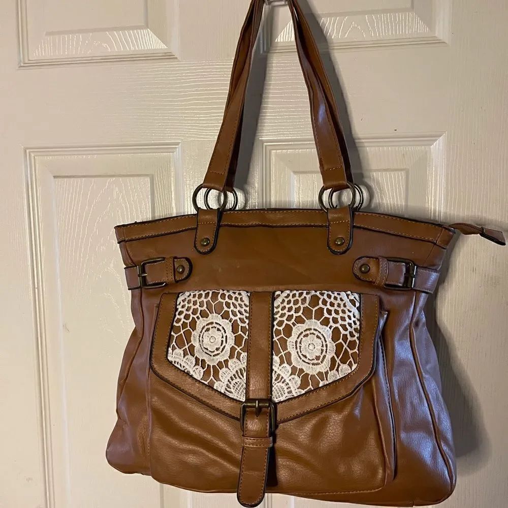 Olivia Miller brown shoulder bag embellished with beige crochet appliqué .